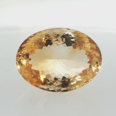 Natural citrine, 106.05 carats, oval cut, clarity: slightly included, golden-yellow color, measuring 36.85 × 27.62 × 17.94 mm