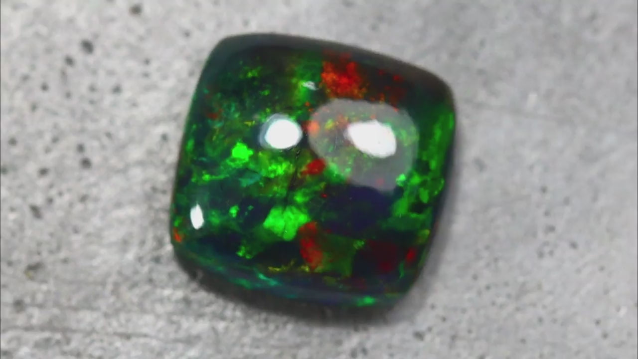 Natural Welo opal, 4.27 carats, cabochon cut, smoked, vivid play-of-color in green, red, and yellow, Ethiopia