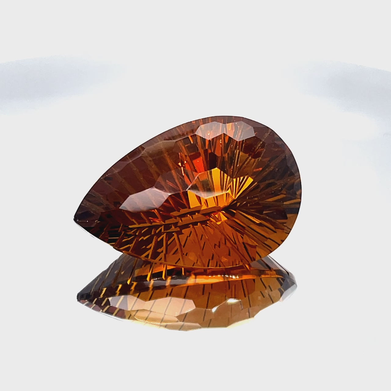 Natural honey citrine, 46.86 carats, pear honeycomb cut, IF clarity, untreated, honey-orange color