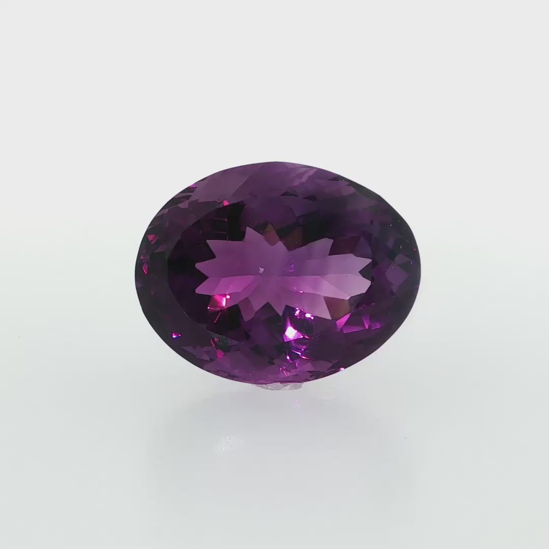 Natural amethyst, 33.56 carats, oval cut, clarity: eye clean, rich purple color, measuring 23.80 × 18.60 × 13.70 mm