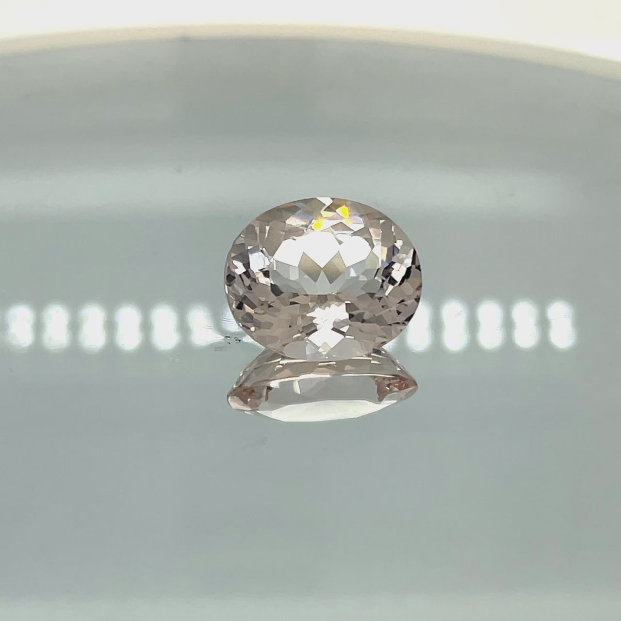 Natural morganite, 8.84 carats, oval cut, VVS clarity, unheated, light pinkish-peach color