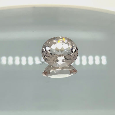 Natural morganite, 8.84 carats, oval cut, VVS clarity, unheated, light pinkish-peach color