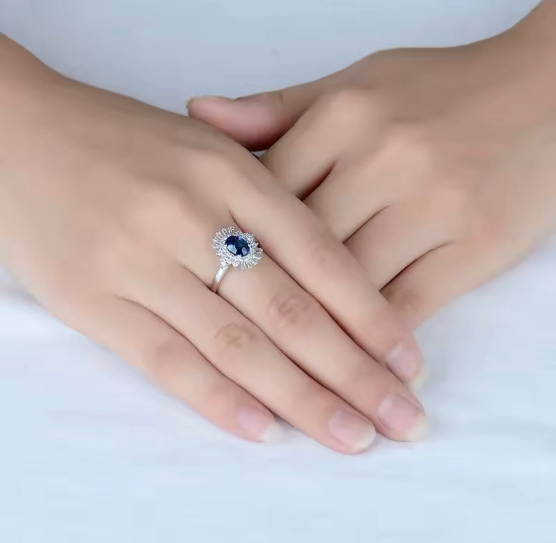 18K white gold sapphire diamond ring with oval natural sapphire and sunburst halo baguette diamonds