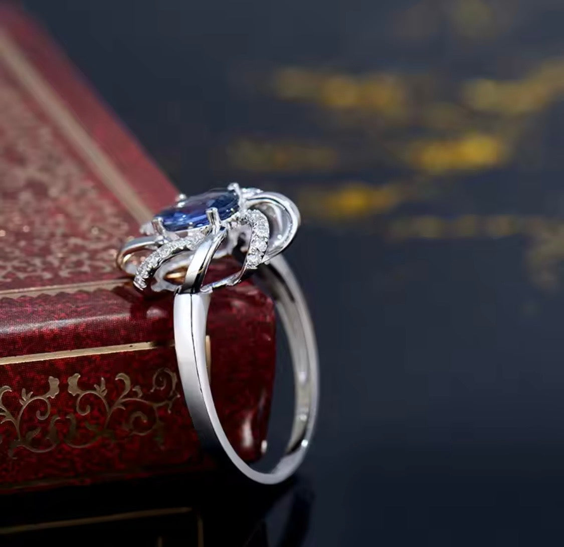 18K white gold sapphire diamond ring with oval natural sapphire and intertwined halo design