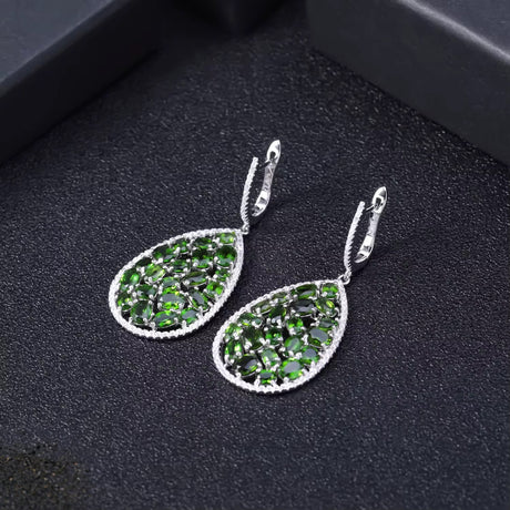 Silver earrings with natural chrome diopside on dark background