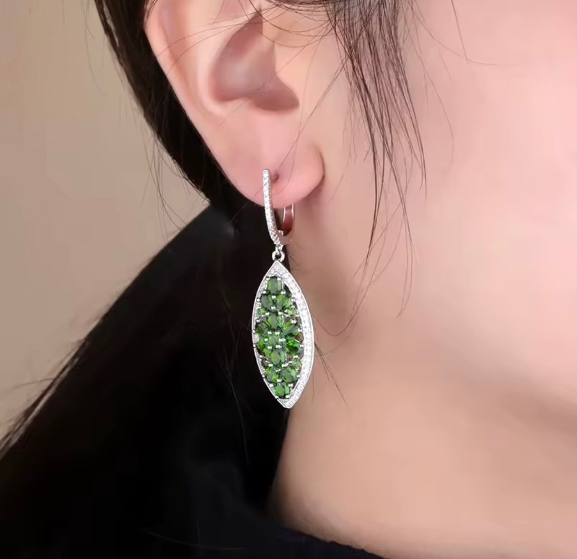 Silver earrings with natural chrome diopside on model
