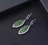 Silver earrings with natural chrome diopside on black background
