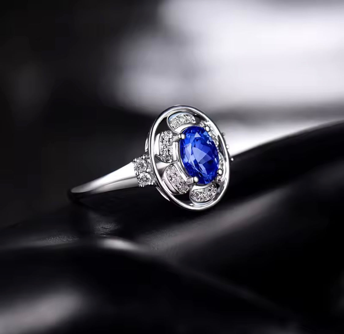 14K white gold tanzanite diamond ring with natural oval tanzanite and diamond halo design