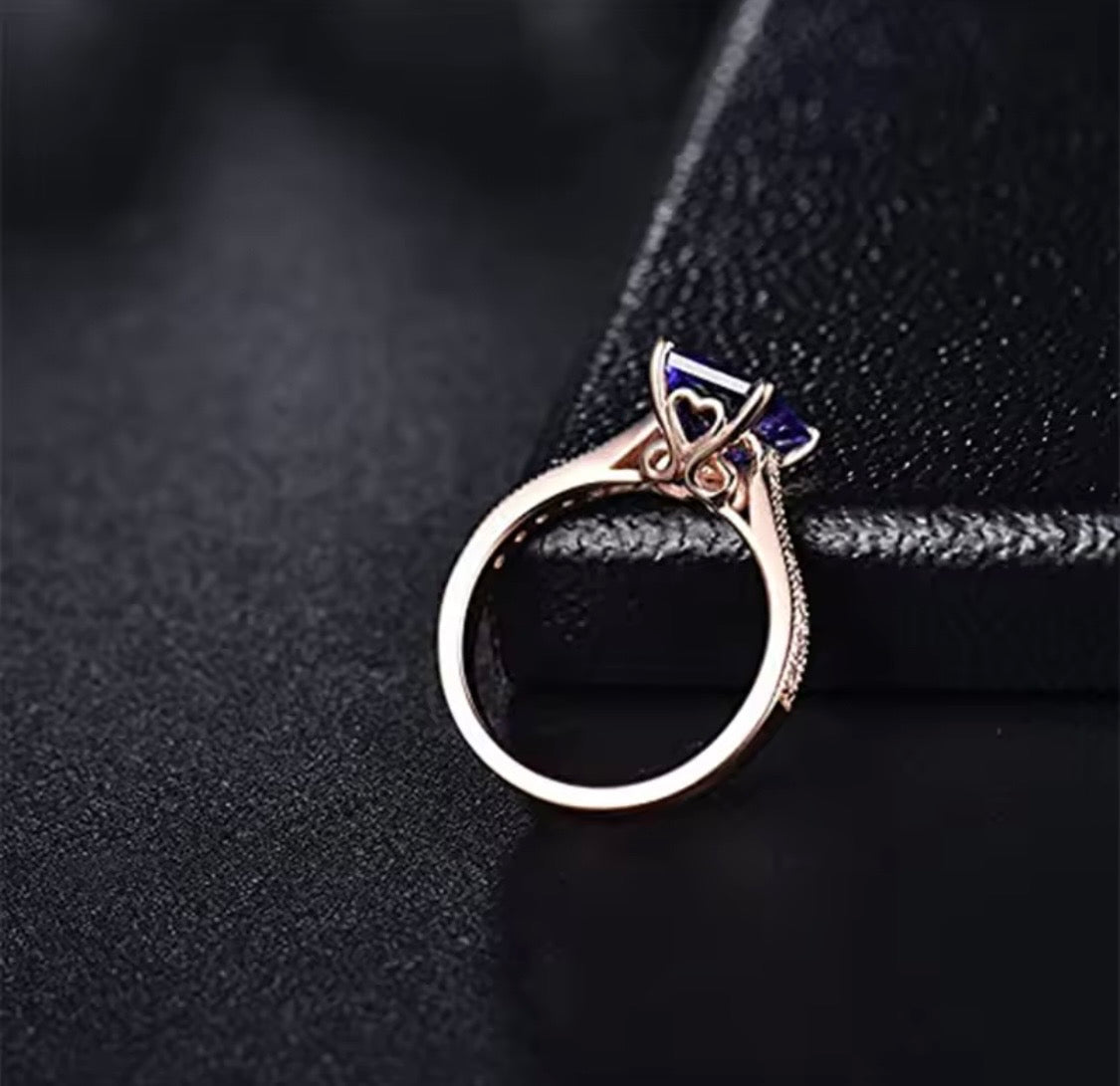 14K rose gold tanzanite engagement ring with natural emerald cut tanzanite and diamond band