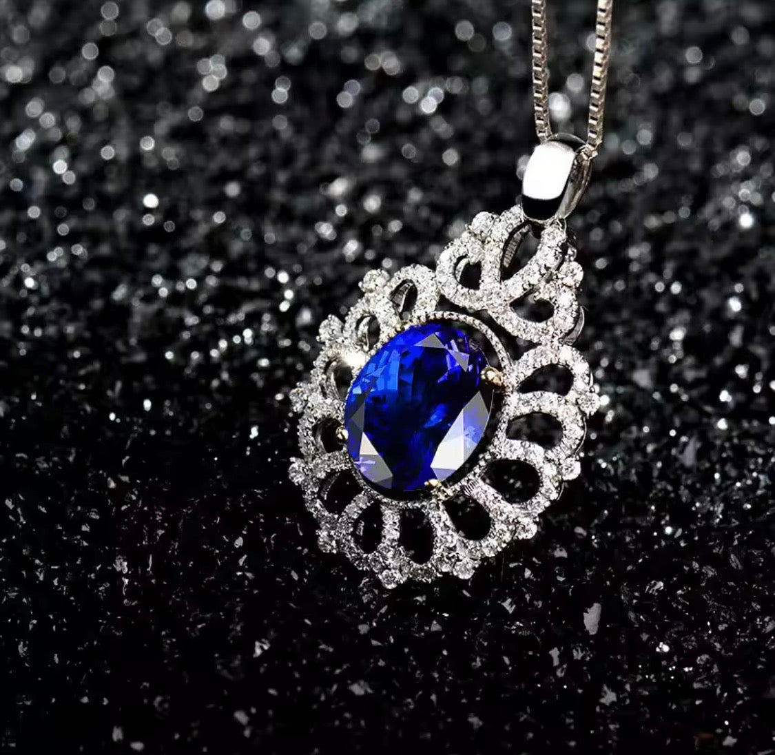 14K gold tanzanite pendant with 4.22 carat oval gemstone and diamond halo design