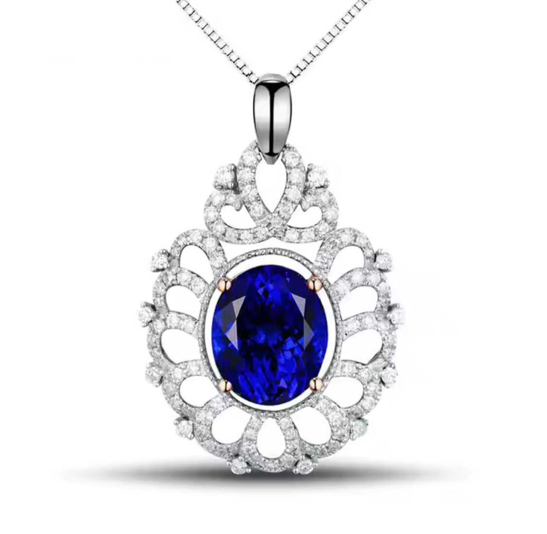 14K gold tanzanite pendant with 4.22 carat oval gemstone and diamond halo design