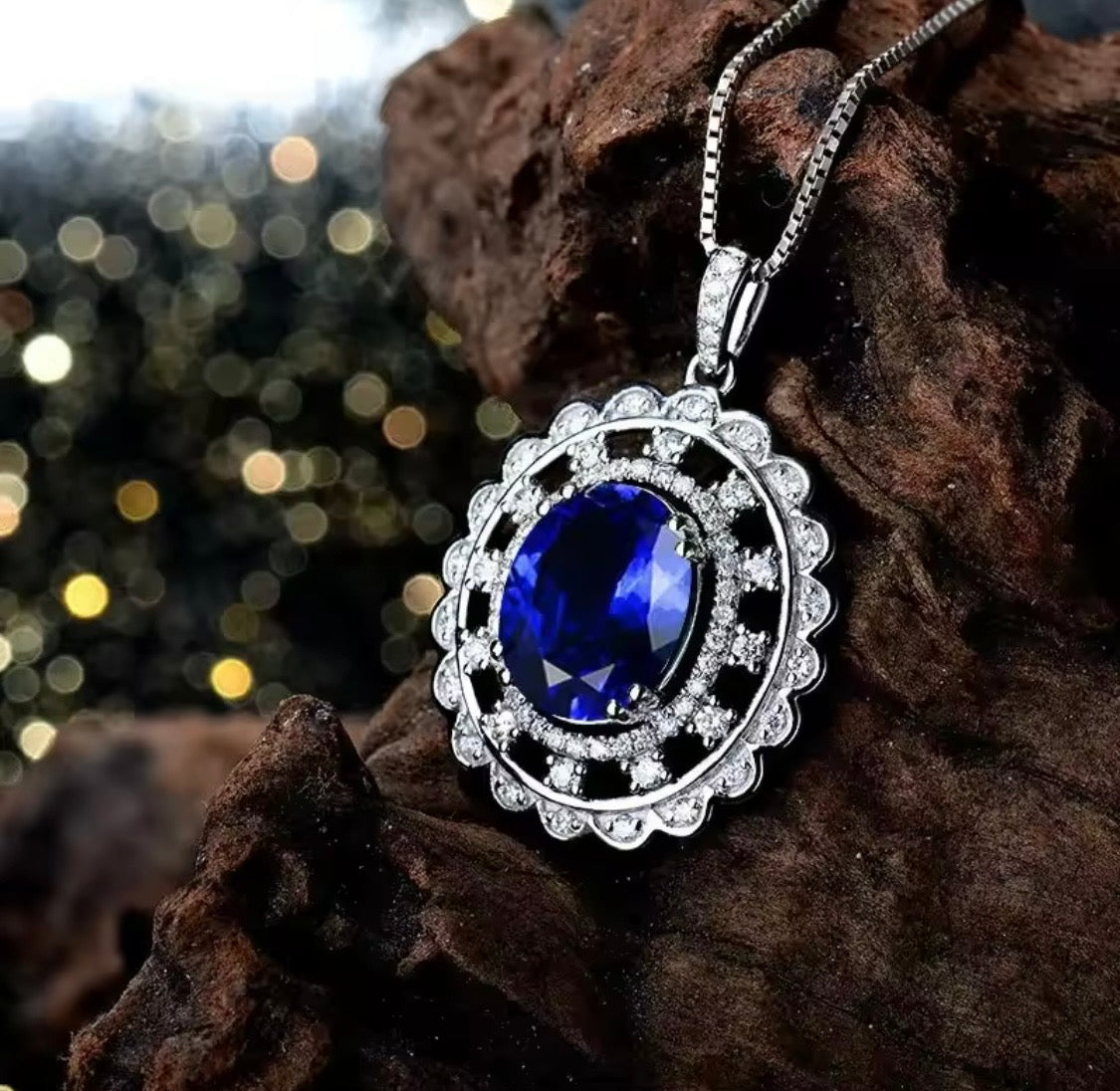 14K gold tanzanite pendant with 4.2 carat oval gemstone and diamond halo design