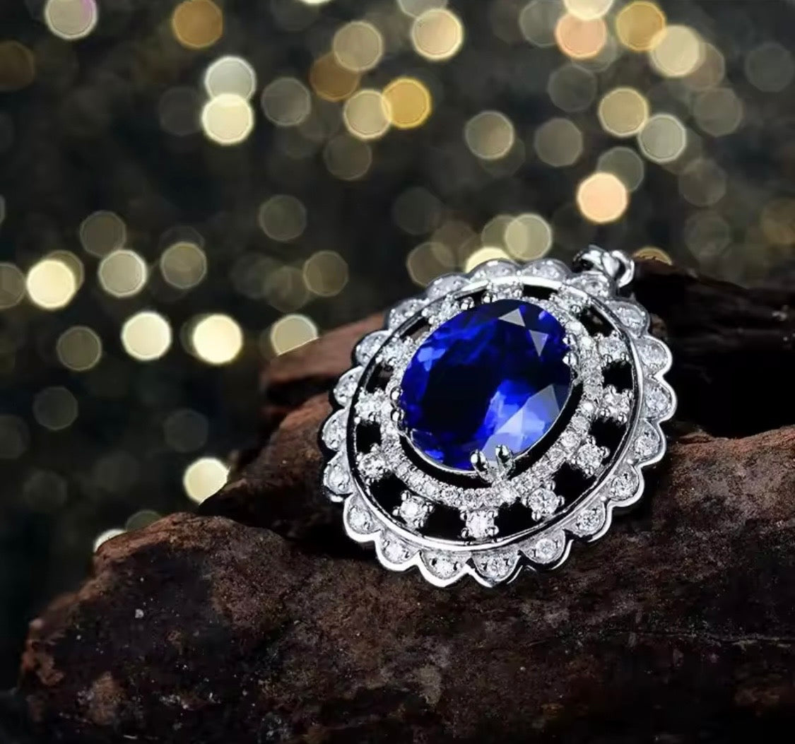 14K gold tanzanite pendant with 4.2 carat oval gemstone and diamond halo design