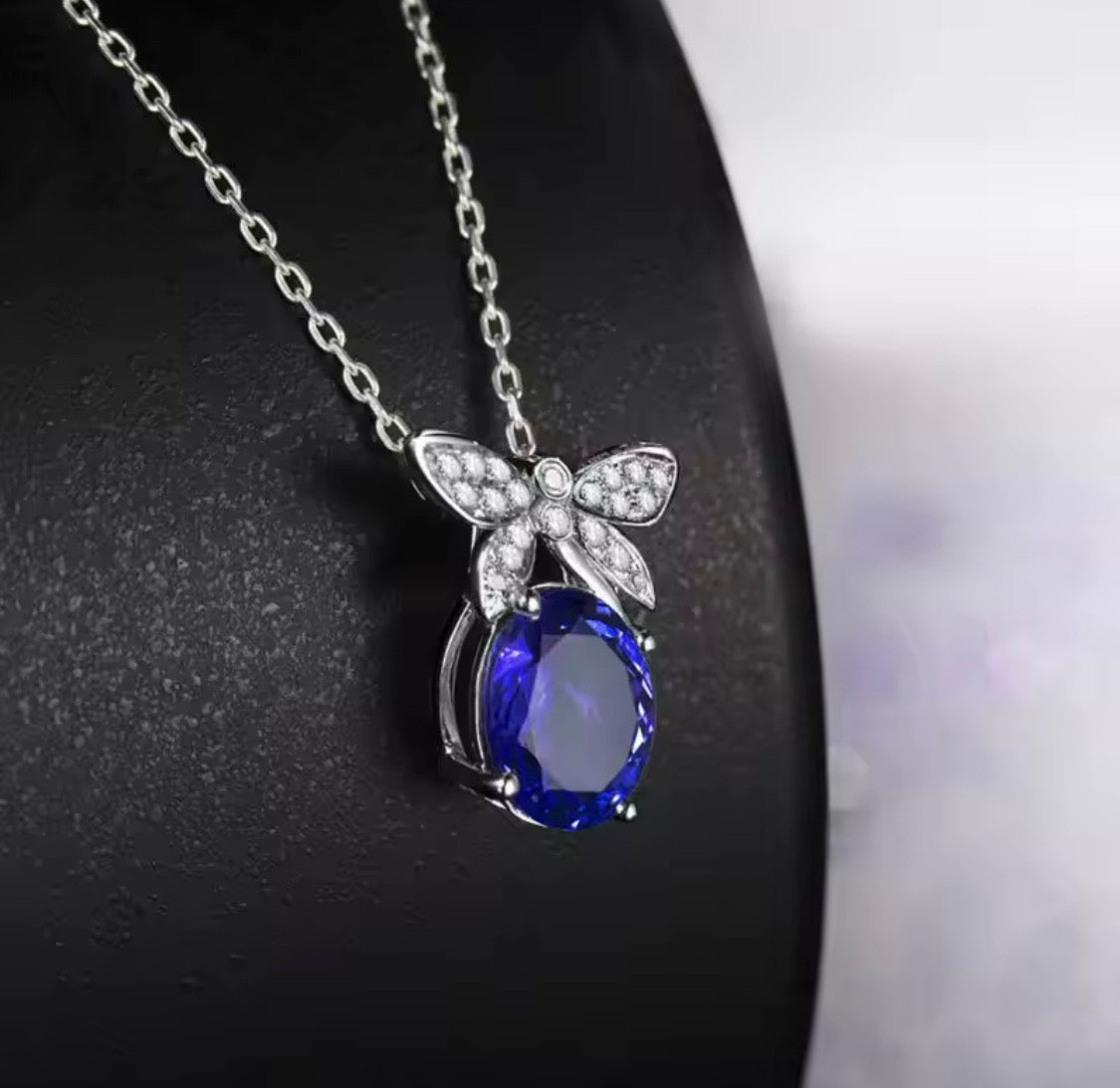 18K gold tanzanite pendant with 2.51 carat oval gemstone and diamond butterfly design