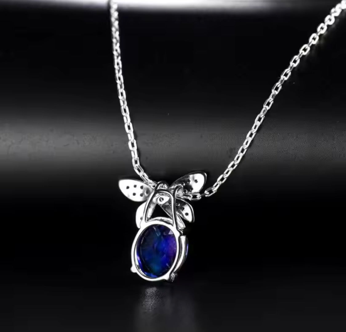 18K gold tanzanite pendant with 2.51 carat oval gemstone and diamond butterfly design