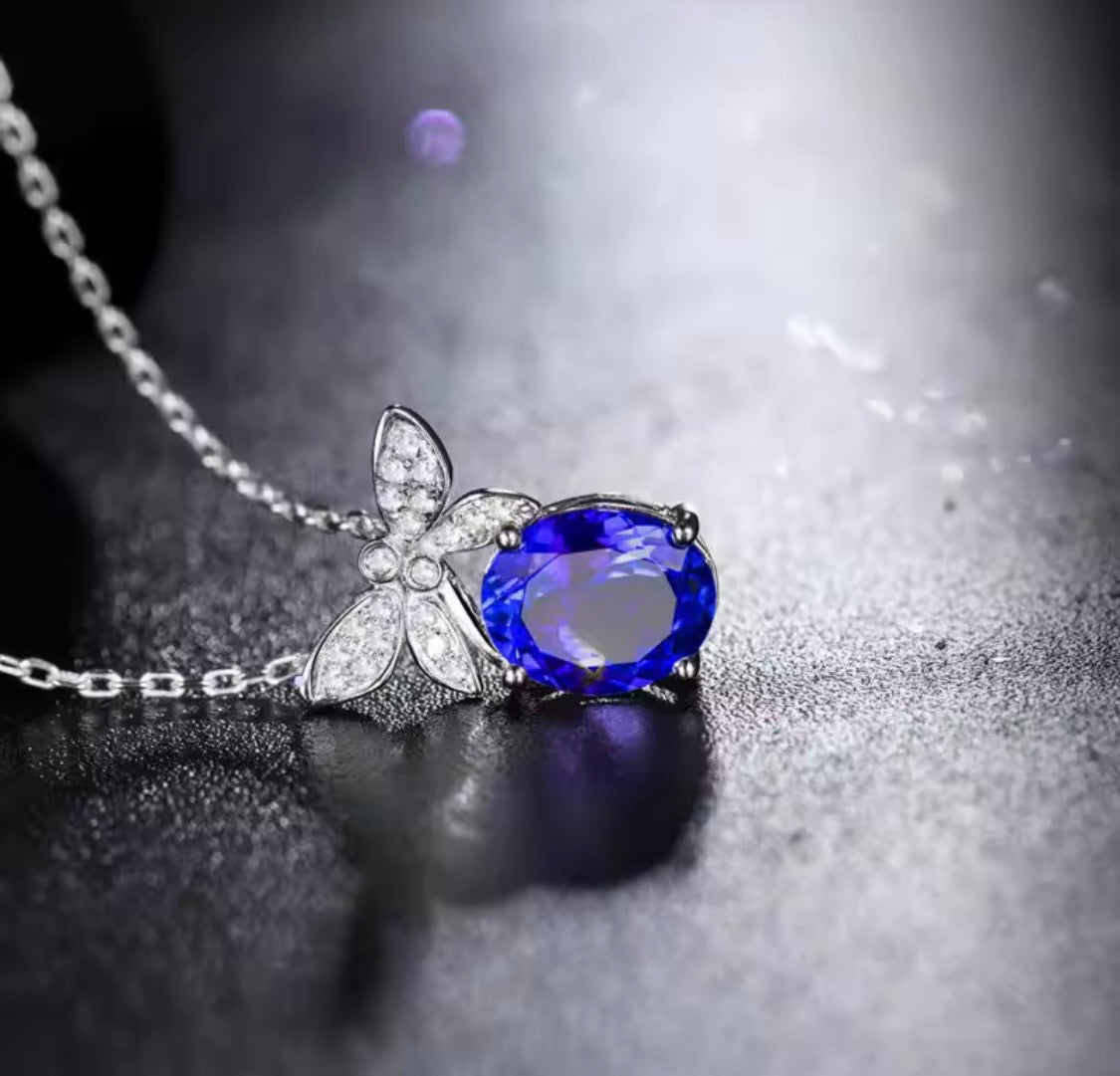 18K gold tanzanite pendant with 2.51 carat oval gemstone and diamond butterfly design
