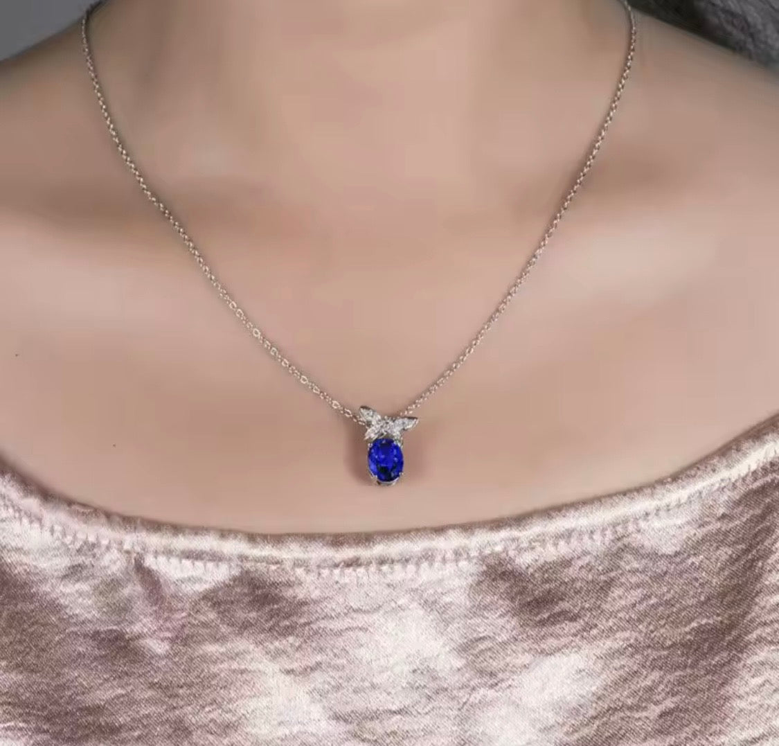 18K gold tanzanite pendant with 2.51 carat oval gemstone and diamond butterfly design