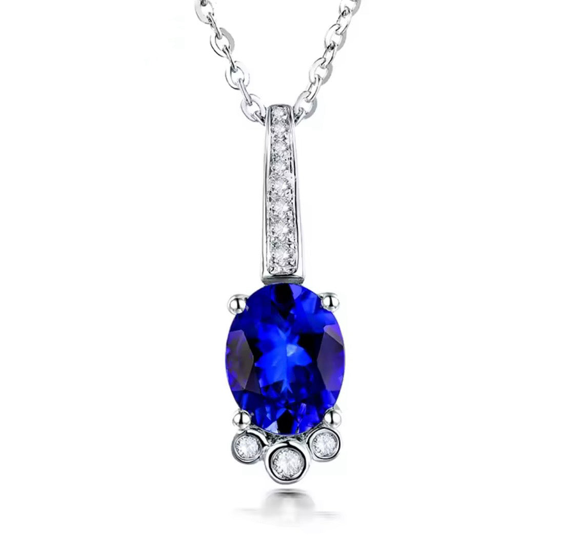 18K gold tanzanite pendant with oval 7x9mm gemstone and diamond drop design