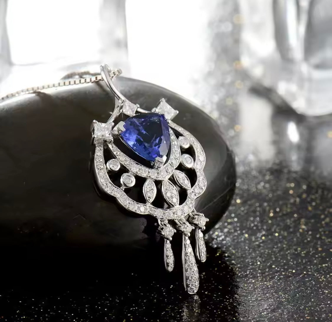 18K gold tanzanite pendant with trillion cut gemstone and diamond design