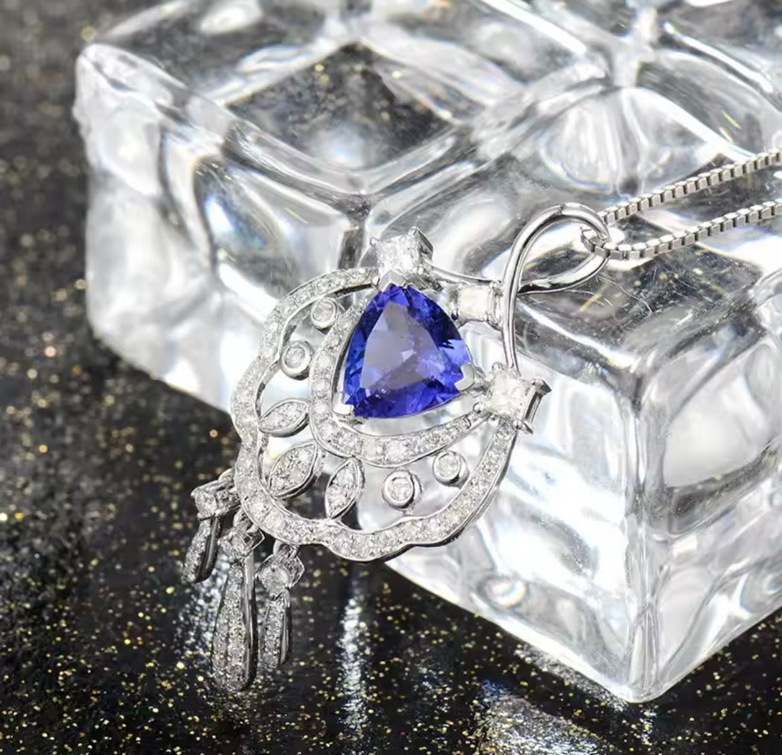 18K gold tanzanite pendant with trillion cut gemstone and diamond design